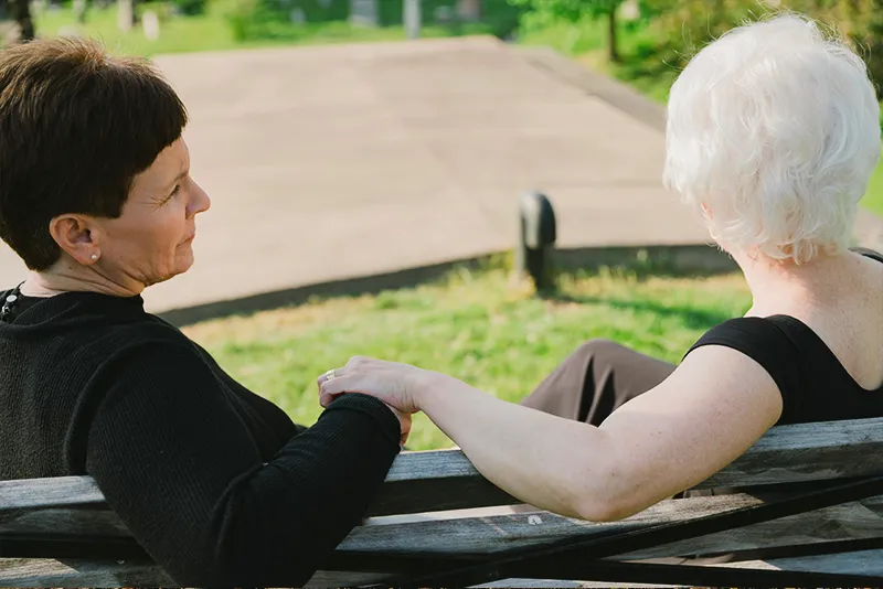 Two people connecting, offering comfort and caregiver support